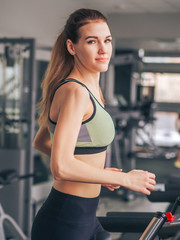 Young girl makes exercises at the gym