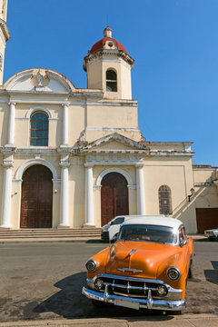 Old cars parked in the Jos&eacute; Mart&iacute; Park, in front of the Purisima Concepcion Cathedral. Cienfuegos, Cuba.