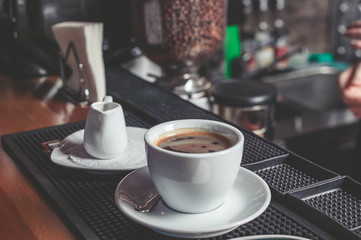 Cup of coffee on a table in cafe. Easy toning