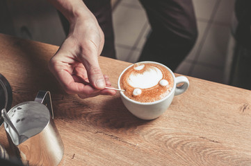 The barista prepare a cup of a latte. Easy toning