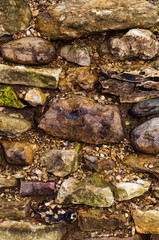 The wall of raw stone. Laying of wild stone. Rough masonry. 