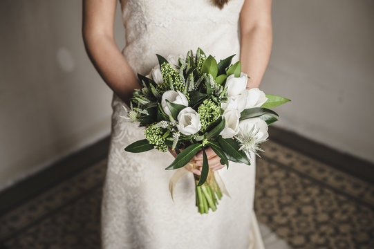 Bride holding her white bridal bouquet