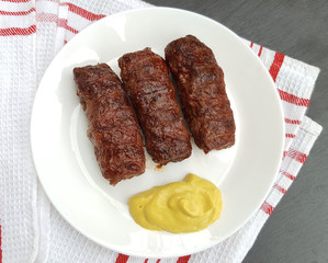 Meat rolls (mititei or mici ) traditional romanian food with mustard