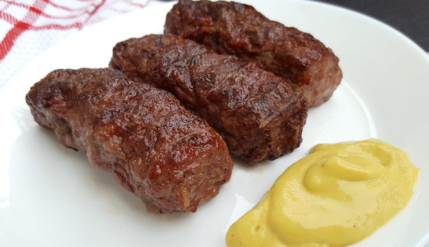 Meat rolls (mititei or mici ) traditional romanian food with mustard