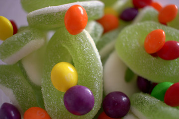 close up green sweet sour colored candies