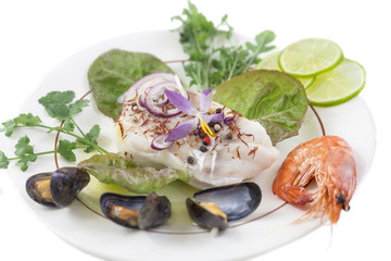 Cod fish fillet, Atlantic cod with seafood mussells,shrimps,lime and vegetable, on white background