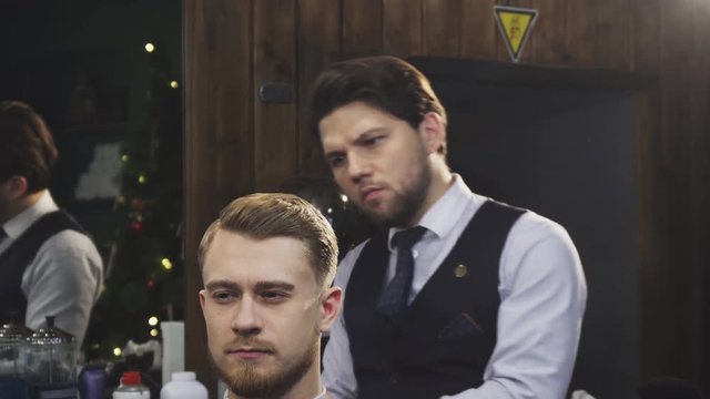 Professional barber using burning fire treatment finishing haircut and styling for his client service dangerous modern technique occupation job consumerism unusual barbering barbershop.