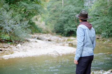 Man walks by the river.