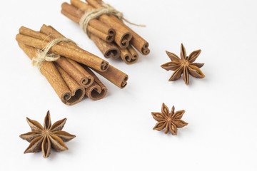 Spices: star anise and cinnamon sticks on white background. Close up. Top view.