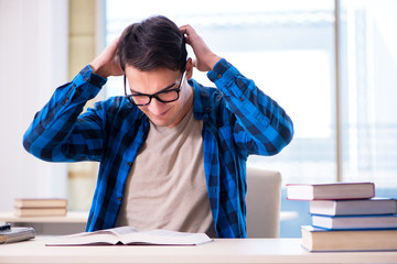 Student studying in the empty library with book preparing for ex