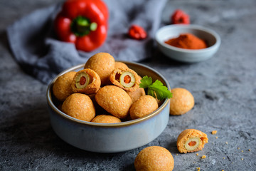 Baked olives in cheese and paprika dough