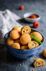 Baked olives in cheese and paprika dough