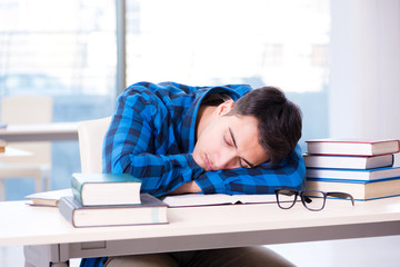 Student studying in the empty library with book preparing for ex