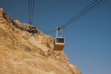 Israel - South - Masada - Aerial ropeway carriage goes from Masada visitor center up to the upper...