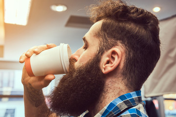 Handsome bearded man in the barbershop.