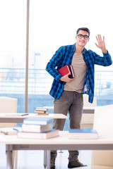 Student studying in the empty library with book preparing for ex
