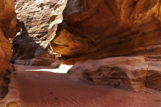 Sand and Rocks in red and orange colors. Path walking to the Treasury, Petra, Jordan