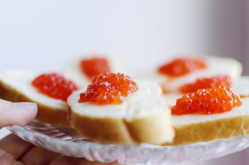 Sandwiches with red caviar lie. Closeup, selective focus.