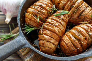 Potatoes in their skins baked with rosemary.