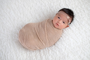 Baby Girl Wrapped in a Beige Swaddle