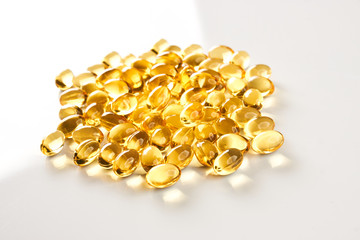 Fish oil pills close-up. Cod liver oil omega 3 gel capsules isolated on white background. Medical...