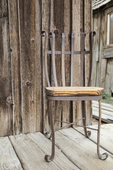Obraz na płótnie Canvas Rusty chair on an old wooden porch