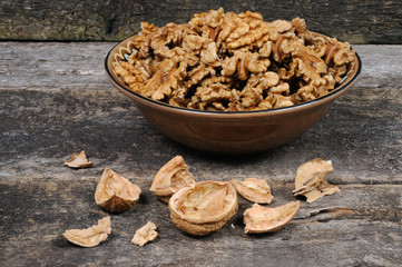 Walnuts without shell in a clay plate. Front view.