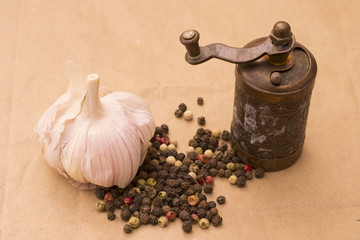 Fugural still life photo image of pile of spices, garlic, craft paper and pepper balls