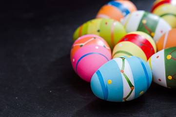Colorized Easter eggs on stone table. Symbol of a Christian religion vacation. Spring folk tradition background.