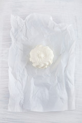 fresh cream cheese on white paper and white wood table can be used as background