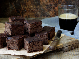 Pieces of cake chocolate brownies on wooden background. Homemade baking. Copy space