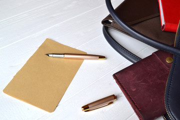 Business bag and empty paper on the desk. Business flat lay.