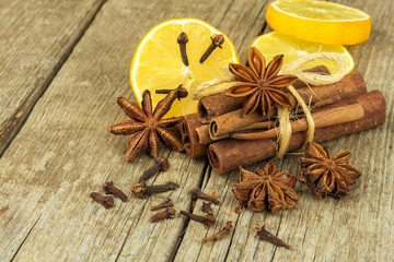 Dried herbs and seasoning. Star of anise, cinnamon sticks and cloves lying on wooden table, seasoning for cooking and baking.