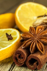 Dried herbs and seasoning. Star of anise, cinnamon sticks and cloves lying on wooden table, seasoning for cooking and baking.