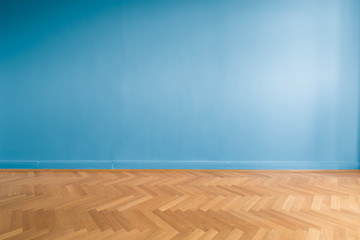 blue wall  in empty room with parquet floor
