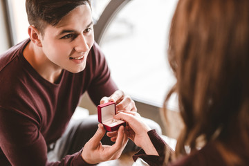 The happy man makes a proposal to his girlfriend in the restaurant