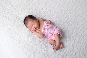 Newborn Baby Girl Wearing a Pink Romper