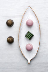 Delicious chocolates handmade with cherries, guava, salted caramel and a match on a white plate and a white background.