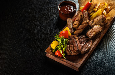 Assorted delicious grilled meat with vegetable. Mixed grilled bbq meat with vegetables. Mixed...