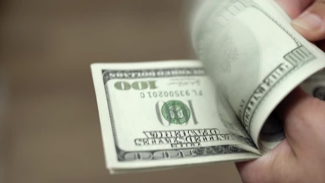 Hands counting dollars