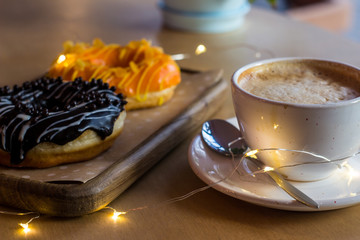 A beautiful breakfast in love with a chocolate donut and coffee
