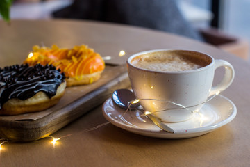 A beautiful breakfast in love with a chocolate donut and coffee
