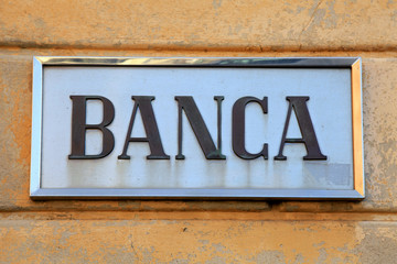 Obraz premium Bank sign on stone wall facade, Italy