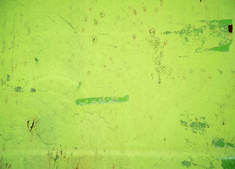 Green old rusty sheet with peeling paint background