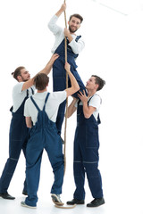 Fototapeta premium group workers help the companion to climb up