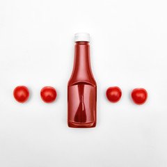 Ketchup Flat lay Bottle of ketchup is lying among juicy cherry tomatoes Photo mockup for advertising with space for text in top view