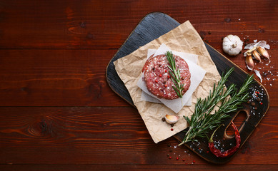 fresh raw cutlets for burger from beef. wooden background, rustic style.