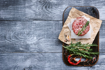 fresh raw cutlets for burger from beef. wooden background, rustic style.