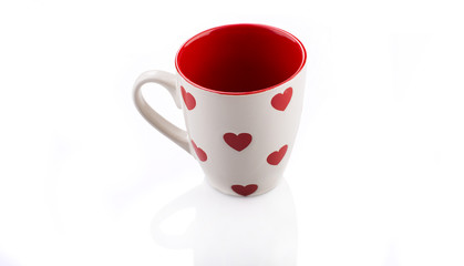 White cup of tea with red hearts on it. Valentine's day.