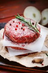 fresh raw cutlets for burger from beef. wooden background, rustic style.